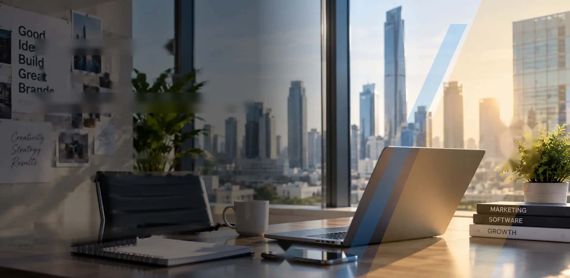 Modern office desk with a laptop overlooking a city skyline at sunrise